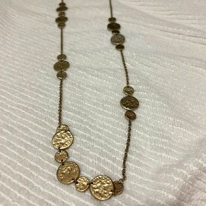 Long chain gold colored necklace